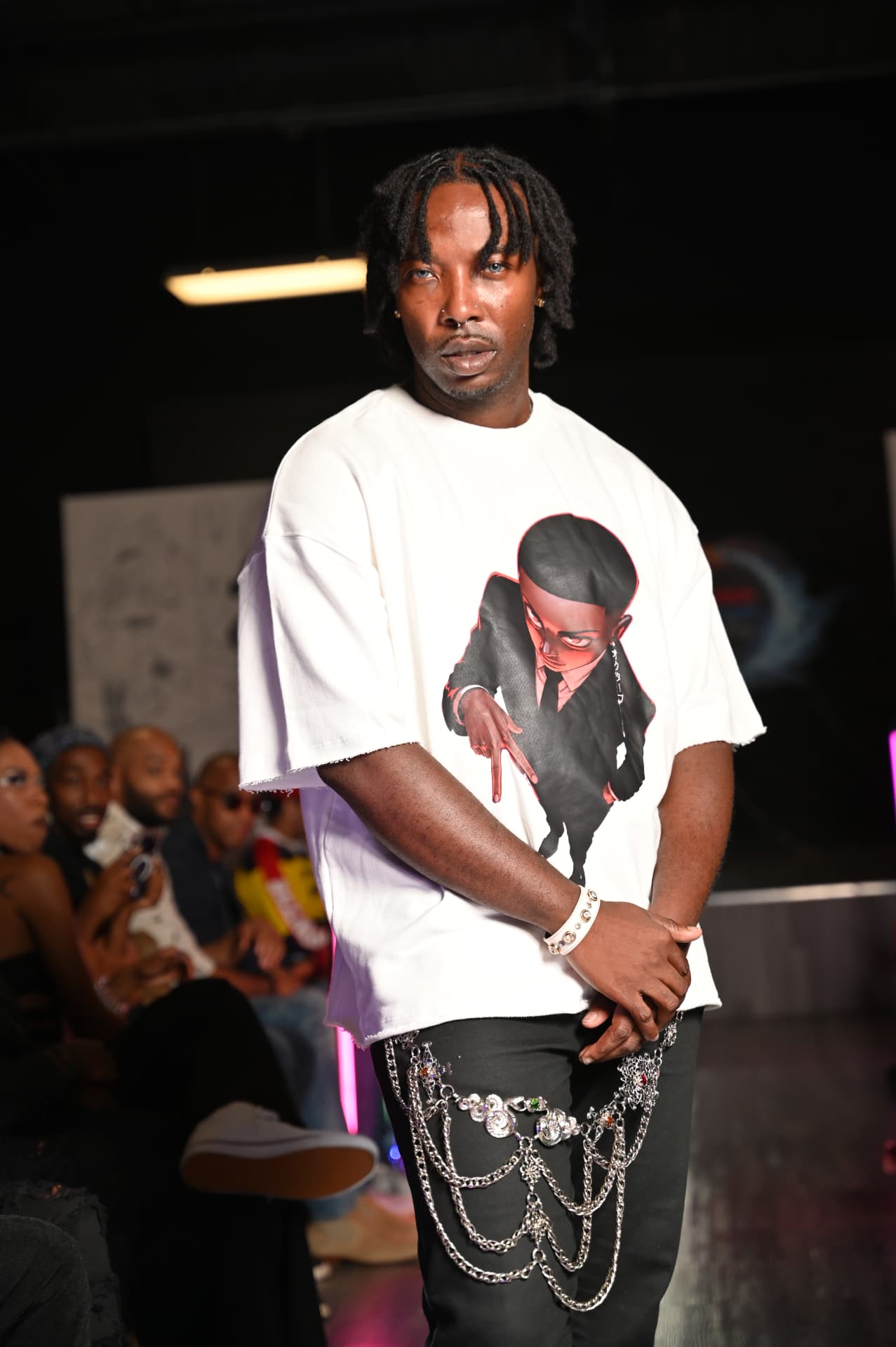 Marseille on the runway in a white Octave anime-graphic tee